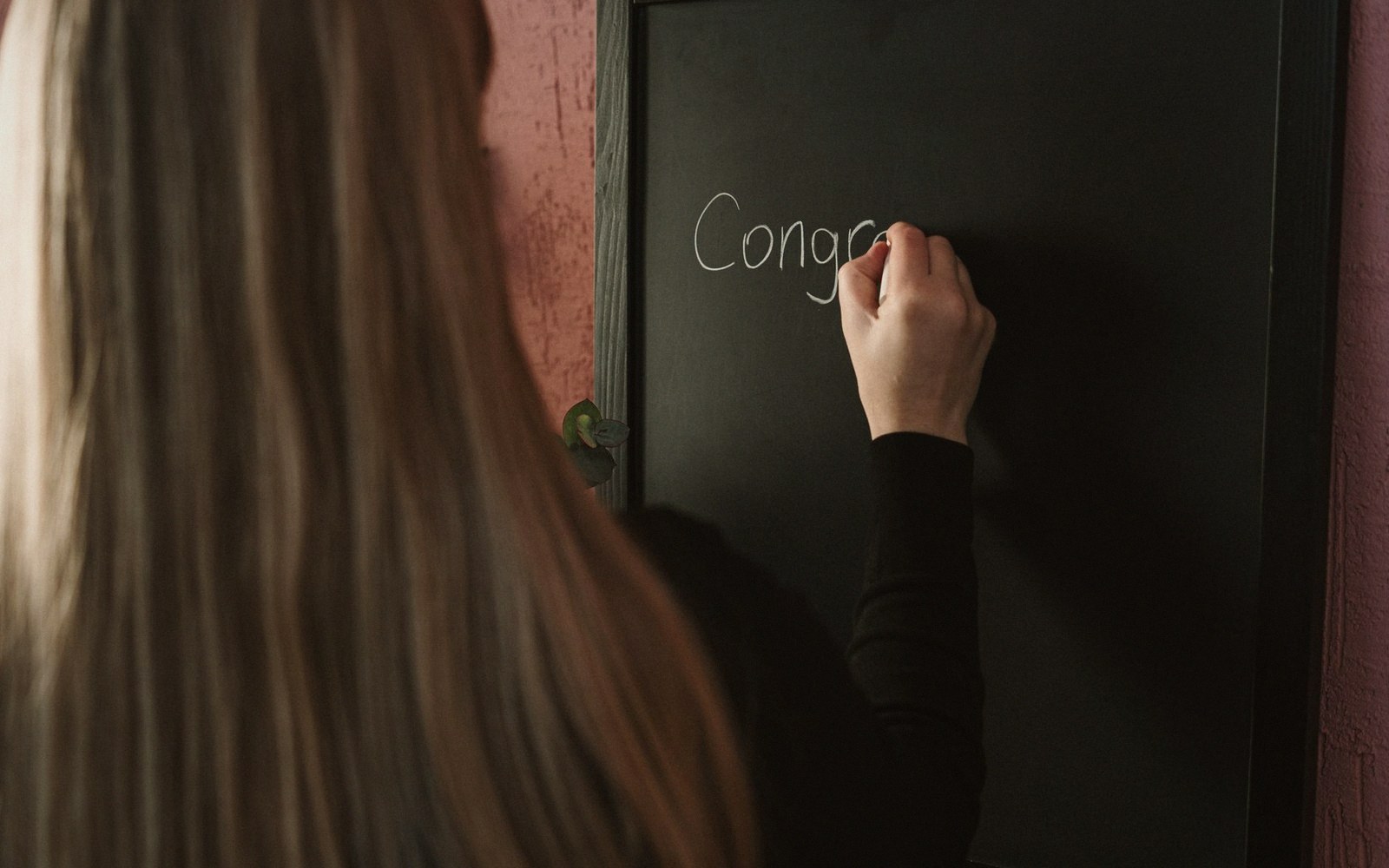 A chalkboard with last week's team scores still written on it