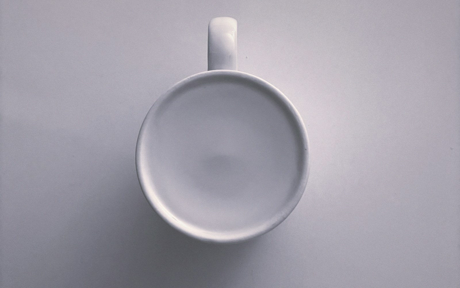 White ceramic cup viewed from directly above against a plain background