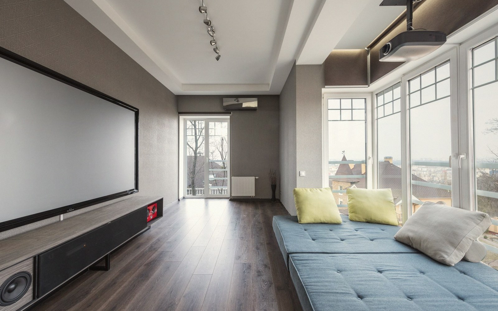 A rolled-up projector screen above an empty pub wall
